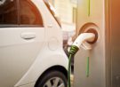 An electric car in charging on the street
