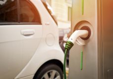 An electric car in charging on the street
