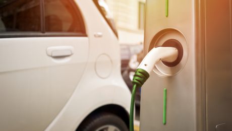 An electric car in charging on the street